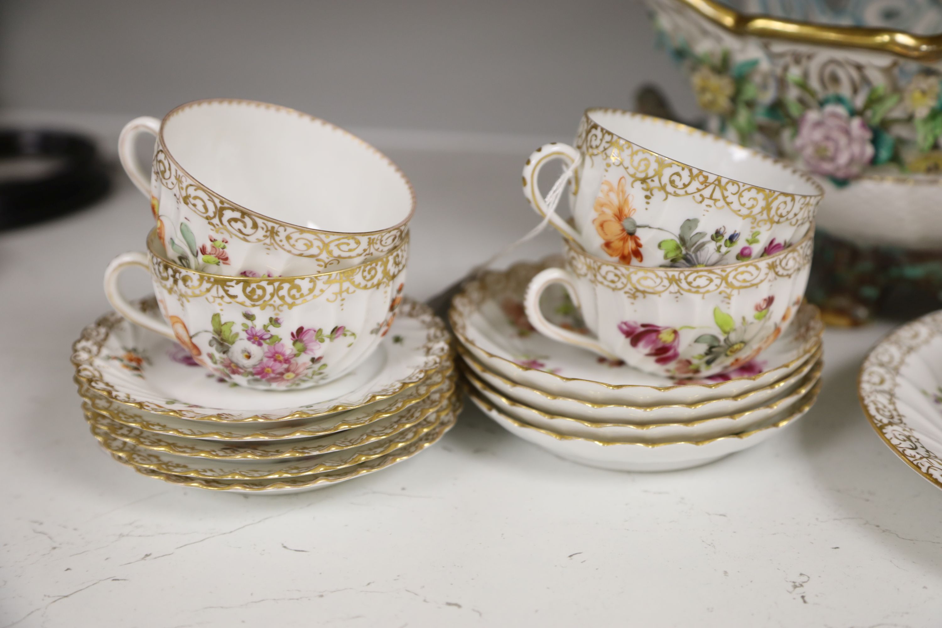 A Dresden-style pierced oval flower-encrusted bowl with branch feet and handles and a Dresden part tea service (15-pce)